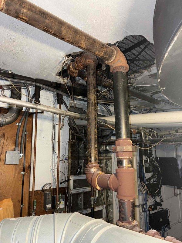Responded to customer-reported boiler leak. Inspection revealed significant corrosion and oxidation on multiple pipes in the boiler system, particularly on copper and iron components. Observed deterioration at pipe joints and ceiling penetrations with evidence of long-term moisture exposure. Identified mixed materials from previous repairs contributing to system vulnerability.