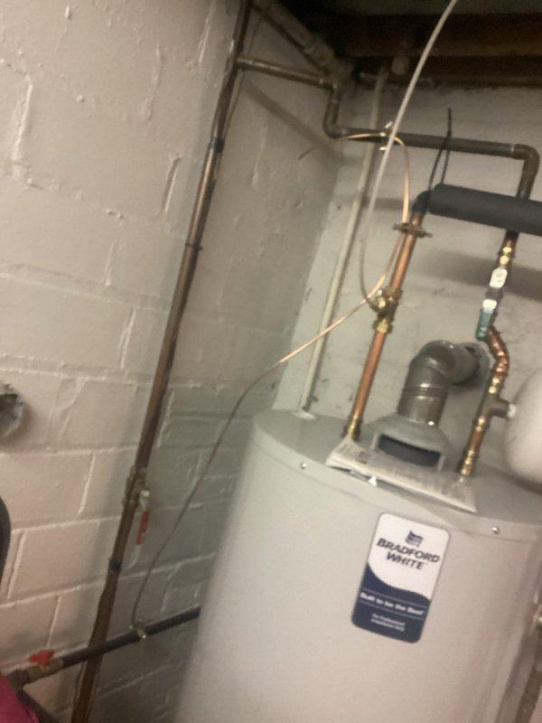 Completed service change as scheduled. Upon inspection, it appears the wrong type of service was documented as photos show only plumbing infrastructure including a Bradford White water heater with associated copper and PVC piping. No electrical panel work was evident in the provided documentation. Customer balance was collected.