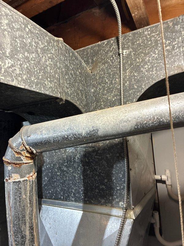 Conducted full system replacement assessment with client. Documented existing system showing significant corrosion at duct elbow joints and aging copper line connections. Client committed to clearing access path to outdoor condenser unit prior to installation.