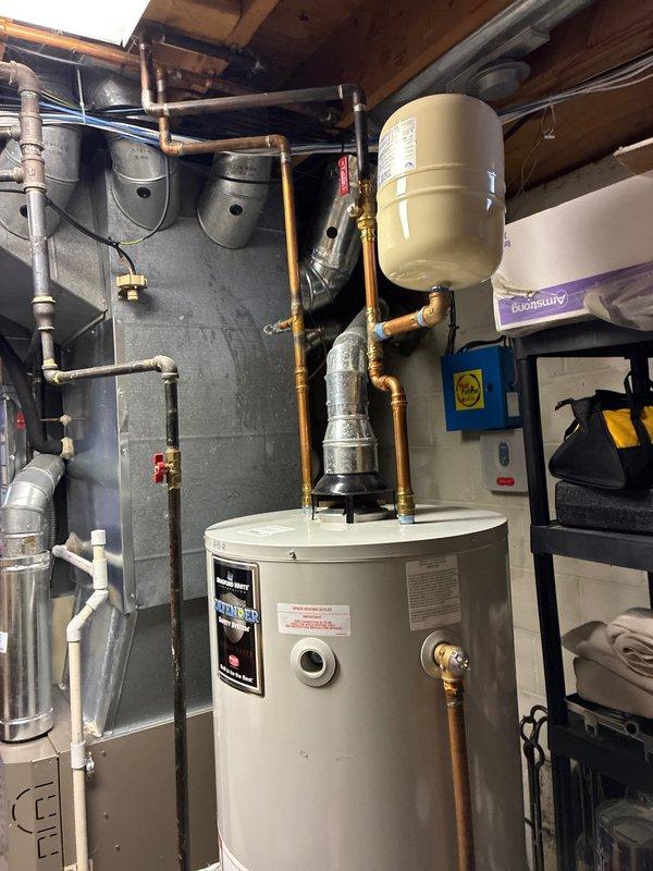 Conducted inspection of heating system where customer's furnace requires significant repairs. Evaluated electrical panel installation with Generac transfer switch for generator backup system. Noted that the AC unit is relatively new and in good condition. Presented replacement options for the furnace while documenting the current water heater setup with expansion tank and associated plumbing in the mechanical room.