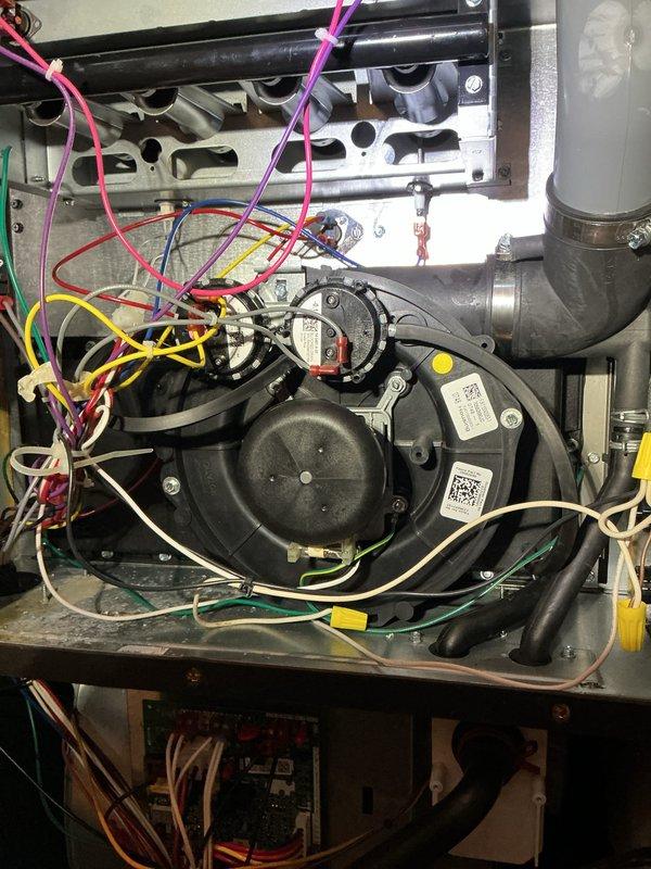 Performed scheduled heating maintenance service on dual-system HVAC setup. Inspected and verified proper operation of both humidifier units mounted on ductwork, confirming all connections and drainage systems were intact. Examined blower motor assembly, checked all electrical connections for security, and verified proper wiring configuration to control modules.
