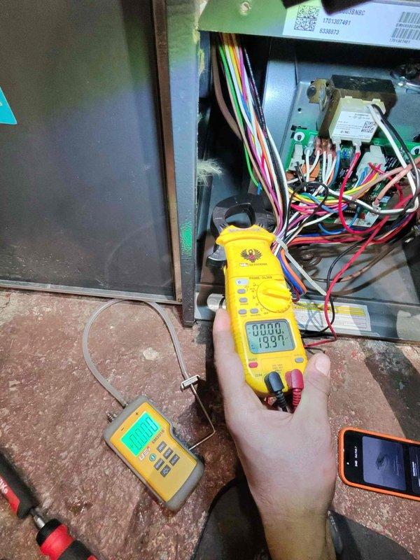 Performed scheduled maintenance on residential furnace system. Conducted electrical diagnostic testing with multimeter, checking voltage readings across control board and components. Inspected internal components with front panel removed, examining wiring connections and ductwork condition.