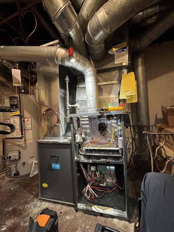 Performed scheduled maintenance on residential furnace system. Conducted electrical diagnostic testing with multimeter, checking voltage readings across control board and components. Inspected internal components with front panel removed, examining wiring connections and ductwork condition.