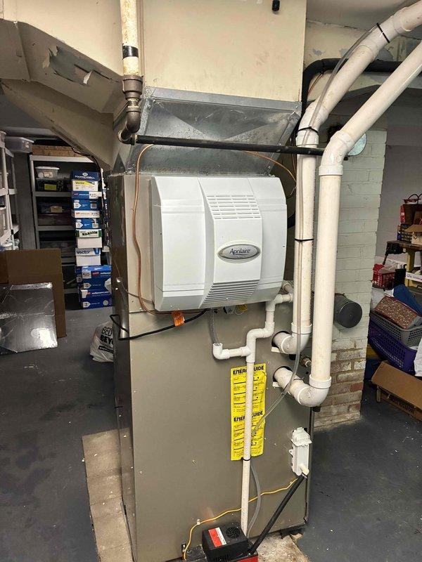 Successfully installed an Aprilaire 700 humidifier on customer's furnace system in the utility room. Unit was properly mounted to the side of the existing HVAC system with all necessary PVC piping, copper tubing, and electrical connections completed according to manufacturer specifications. System was tested and is functioning correctly to improve indoor air quality.