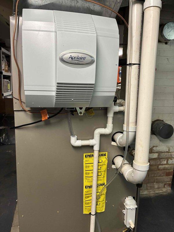 Successfully installed an Aprilaire 700 humidifier on customer's furnace system in the utility room. Unit was properly mounted to the side of the existing HVAC system with all necessary PVC piping, copper tubing, and electrical connections completed according to manufacturer specifications. System was tested and is functioning correctly to improve indoor air quality.