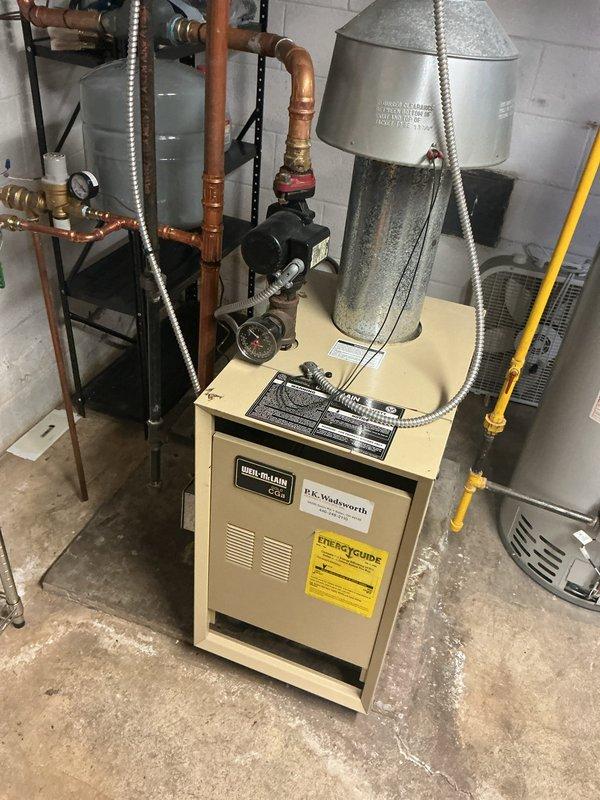 Performed routine maintenance on Weil-McLain boiler heating system. Inspected pressure regulator valve, gauge readings, and all copper pipe connections for proper function. Verified expansion tank integrity and confirmed all plumbing infrastructure is operating within normal parameters.