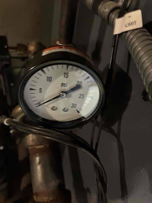 Performed scheduled boiler maintenance service. Inspected control panel showing normal operating temperature (032), checked system pressure which registered at approximately 17-18 PSI (within acceptable range), and verified proper operation of all safety limit controls. All components functioning correctly with no issues identified.