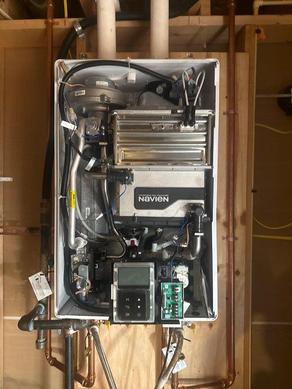 Performed scheduled maintenance on Navien tankless water heater, completing a comprehensive flush and fill service to remove mineral buildup and restore optimal operation. Inspected internal components after removing front panel, ensuring proper function of heat exchangers, fan assembly, and connection points.
