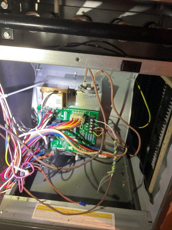 Diagnosed system short cycling issue by examining control board and thermostat functionality. Inspection of circuit board components revealed a failed 20 MFD capacitor causing intermittent operation. Replaced capacitor and verified proper system operation with the Honeywell ProSeries thermostat now maintaining stable heating cycles between set point and ambient temperature.