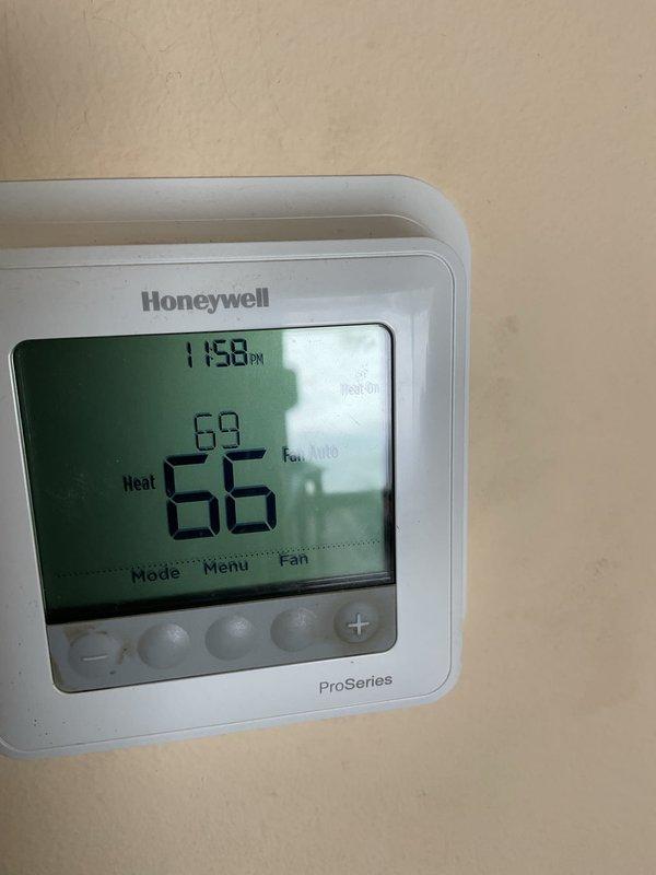 Diagnosed system short cycling issue by examining control board and thermostat functionality. Inspection of circuit board components revealed a failed 20 MFD capacitor causing intermittent operation. Replaced capacitor and verified proper system operation with the Honeywell ProSeries thermostat now maintaining stable heating cycles between set point and ambient temperature.