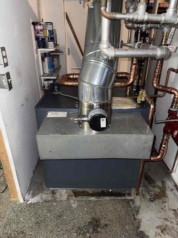 Successfully installed new high-efficiency boiler system with comprehensive piping network including galvanized and copper components. Connected all necessary supply lines, return pipes, and installed circulation pump (red component). System was fully tested and is operating at optimal performance.