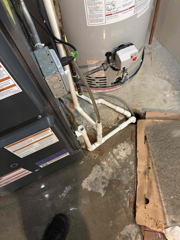 Responded to emergency service call for water leakage from humidifier connected to basement furnace. Inspection revealed moisture accumulation around the water heater and HVAC system with water staining on concrete floor. Serviced humidifier components, adjusted water feed line, and verified proper drainage to resolve the flooding issue.