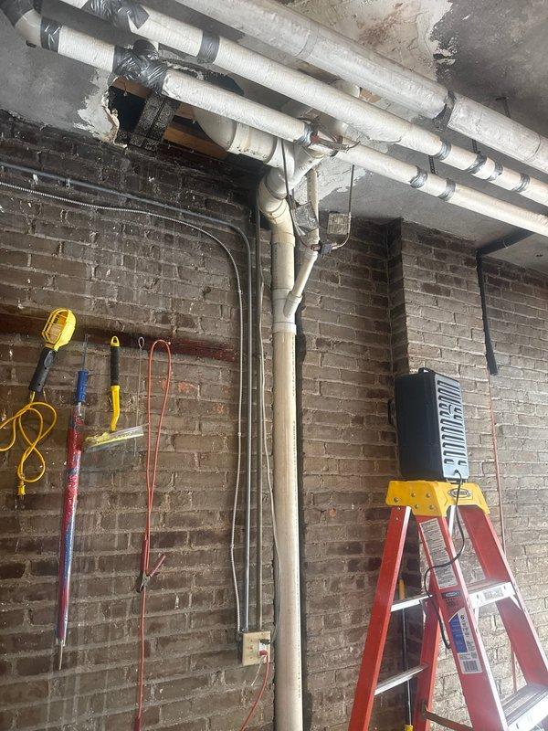 Conducted comprehensive plumbing inspection of outdoor water supply system. Examined PVC piping configuration and identified areas of water damage where pipes penetrate ceiling. Observed potential leak indicators including white mineral deposits at pipe joints and inspected insulation integrity on water lines.