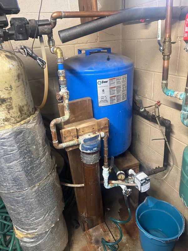 Replaced corroded copper supply lines and fittings on customer's water softener system. Observed significant oxidation and mineral buildup on multiple connection points, particularly where pipes connect to the blue pressure tank. Restored proper functionality to prevent potential leaks and system failure.