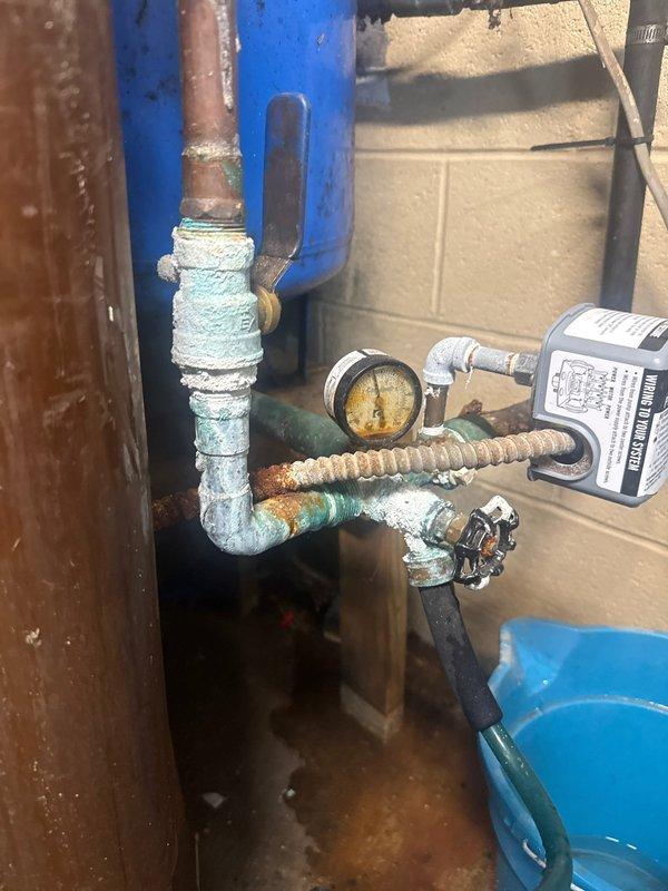 Replaced corroded copper supply lines and fittings on customer's water softener system. Observed significant oxidation and mineral buildup on multiple connection points, particularly where pipes connect to the blue pressure tank. Restored proper functionality to prevent potential leaks and system failure.
