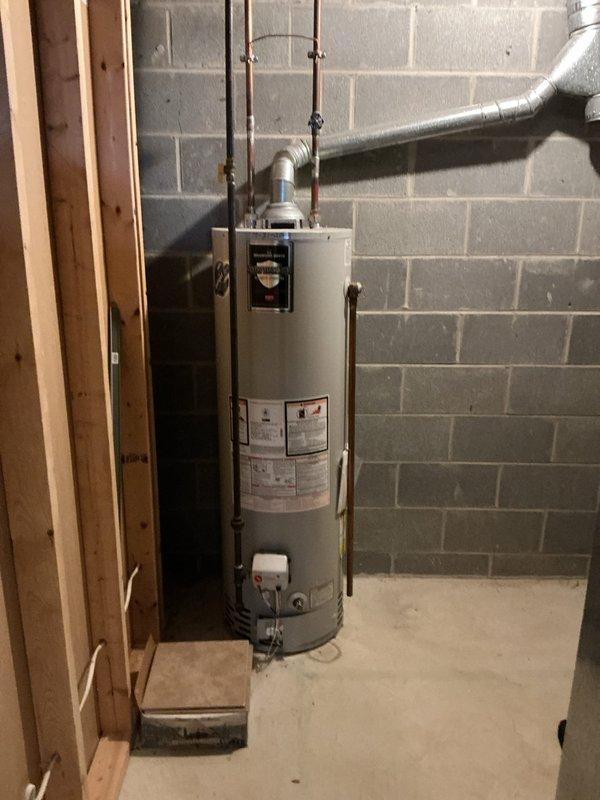 Performed routine heating maintenance on water heater system. Inspected interior components including motor housing, ducting, and electrical connections. System appears to be in normal working condition with no visible damage detected.