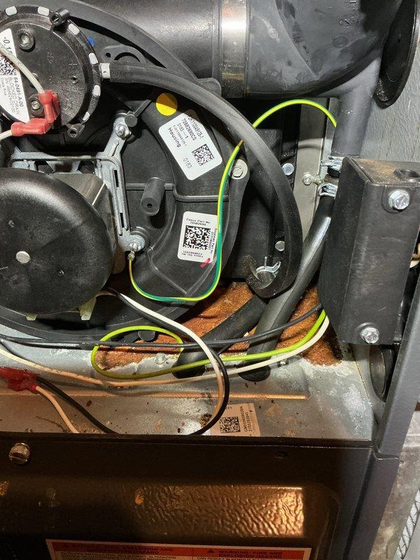 Performed routine heating maintenance on water heater system. Inspected interior components including motor housing, ducting, and electrical connections. System appears to be in normal working condition with no visible damage detected.