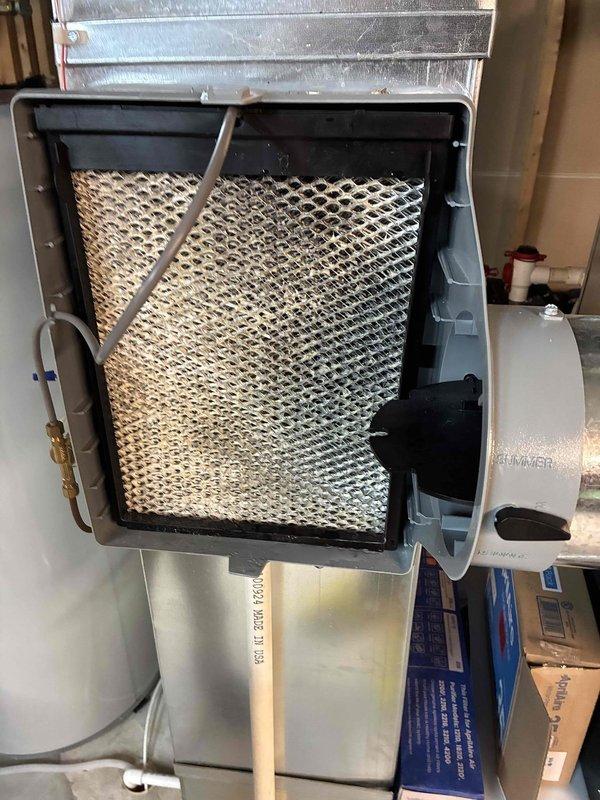 Responded to service call regarding humidifier leakage affecting furnace. Upon inspection, discovered heavily discolored and mineral-deposited evaporative pad in the humidifier unit. Replaced humidifier pad and adjusted water supply to prevent further leakage issues.