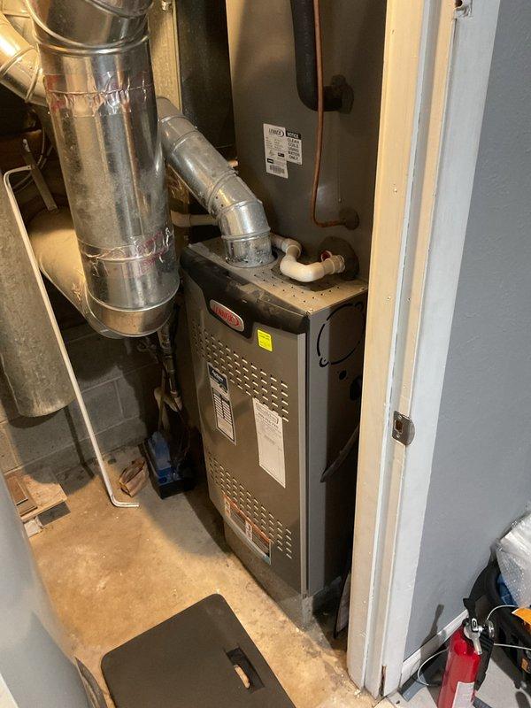 Performed comprehensive system check for new homeowner. Inspected residential furnace unit located in utility area, including verification of proper ventilation, gas supply connections, and condensate drainage system. No operational issues identified during inspection.