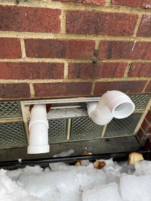 Responded to service call for water leaking from PVC condensate drain line in basement. Inspection revealed improper slope on exterior exhaust pipe causing condensate backup. Adjusted pitch of PVC drain line to ensure proper drainage and prevent future leakage. System now functioning normally.