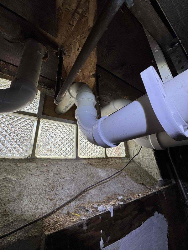 Responded to service call for water leaking from PVC condensate drain line in basement. Inspection revealed improper slope on exterior exhaust pipe causing condensate backup. Adjusted pitch of PVC drain line to ensure proper drainage and prevent future leakage. System now functioning normally.