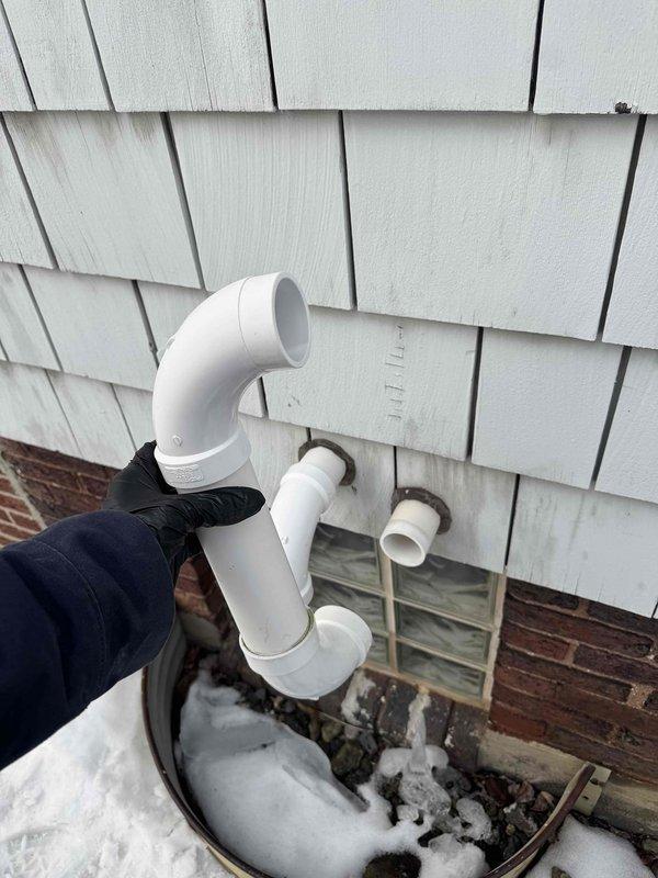 Responded to customer report of icicle damage to furnace vent. Inspected exterior PVC venting system and found vent pipe disconnected from house. Repaired and reinstalled the furnace exhaust vent piping, ensuring proper connection and alignment to prevent future ice buildup issues.