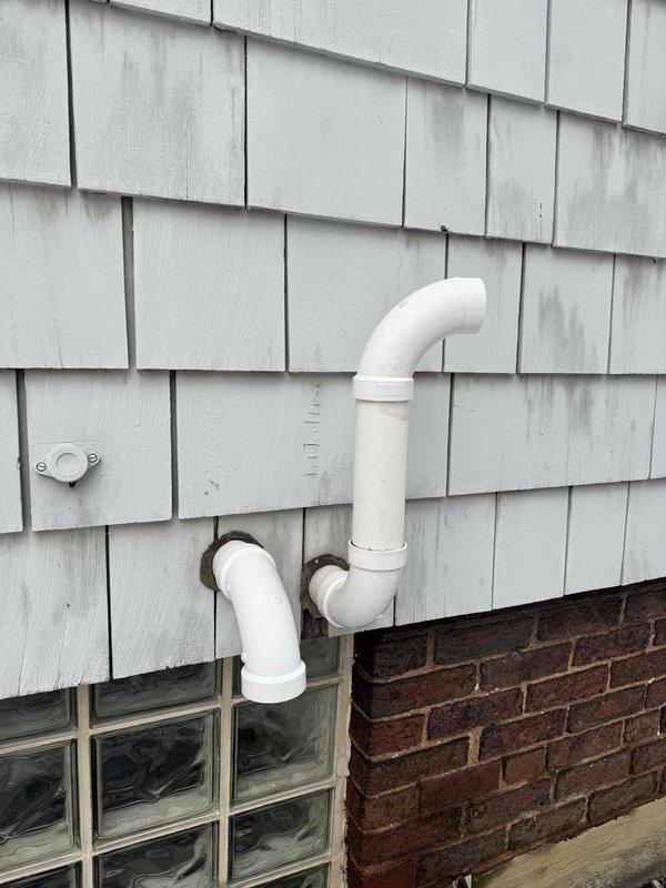 Responded to customer report of icicle damage to furnace vent. Inspected exterior PVC venting system and found vent pipe disconnected from house. Repaired and reinstalled the furnace exhaust vent piping, ensuring proper connection and alignment to prevent future ice buildup issues.