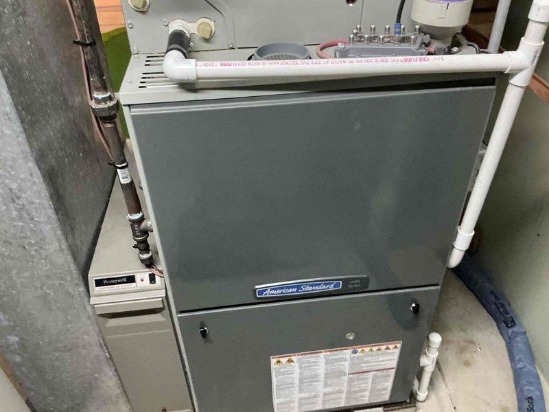 Diagnosed American Standard furnace with cracked heat exchanger, requiring replacement. Documented existing system components including PVC venting infrastructure and Honeywell control unit. Presented replacement options for furnace and potentially complete HVAC system to address safety concerns.