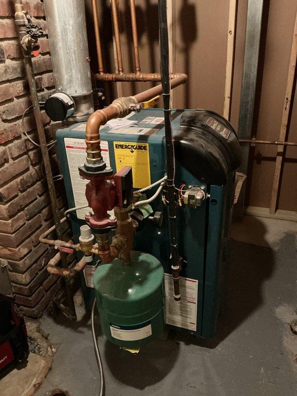 Performed scheduled maintenance on residential boiler system. Inspected electrical connections in breaker panel, ensuring proper wire nut connections and circuit integrity. Examined boiler unit with associated copper piping network, circulator pump, and expansion tank for proper operation and signs of wear.