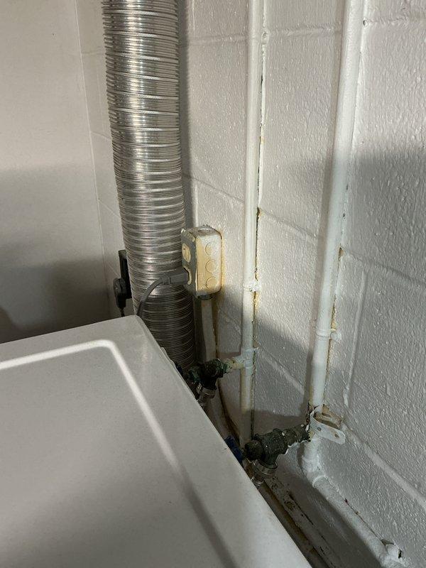 Conducted comprehensive electrical panel inspection, documenting the condition of circuit breakers, wiring connections, and safety labels. Panel showed proper installation with appropriate hot, neutral, and ground wire configuration, though some areas near the utility basin showed minor water damage and rust on nearby plumbing components.