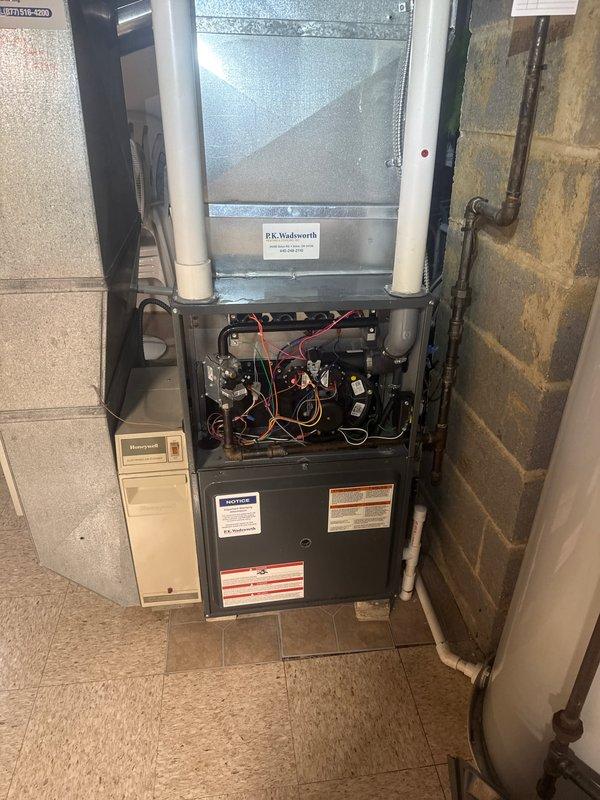 Performed scheduled heating tune-up on residential furnace system, including inspection of internal electrical components and wiring connections. Accessed and examined control modules, motor assembly, and humidifier attachment. Completed comprehensive system check with all panels properly secured upon completion.