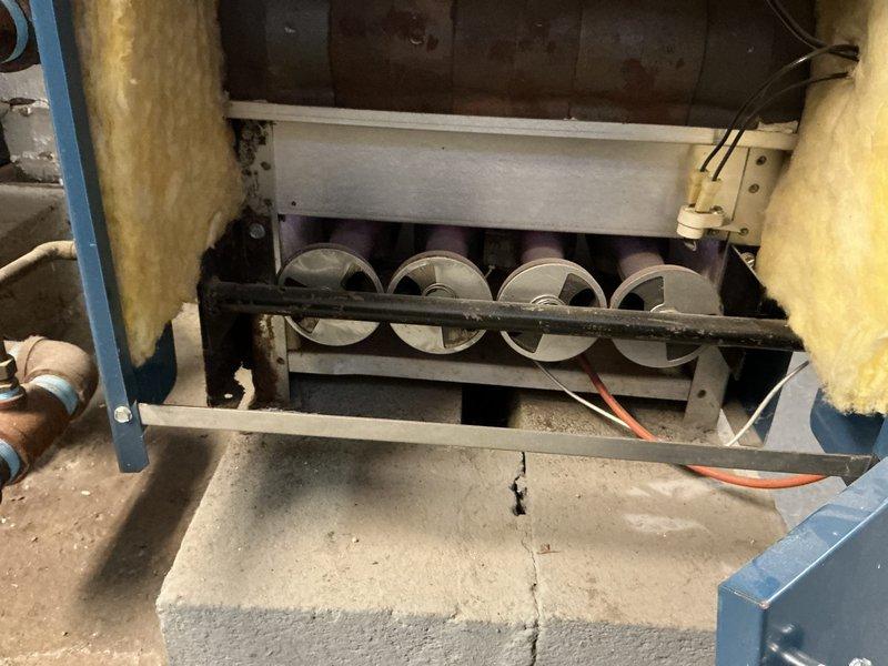 Conducted comprehensive boiler assessment for rental property at landlord's request. Inspected aging system with visible dust accumulation in fan assembly and examined the blue boiler unit with its galvanized exhaust vent and copper piping connections. Presented replacement options to address system condition and improve heating efficiency.