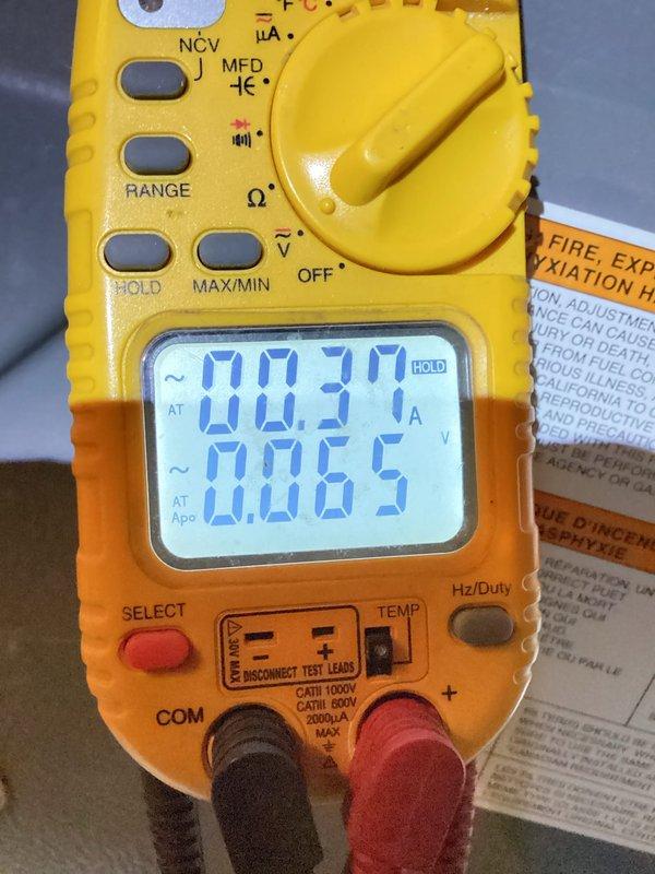 Performed routine heating tune-up service on the system. Conducted electrical diagnostics with multimeter showing 0.31A current draw and 0.065V, confirming proper electrical operation. Measured gas pressure with manometer reading at 3.66" WC, verifying correct gas supply to unit. Air conditioning system operational but not tested during this heating maintenance visit.