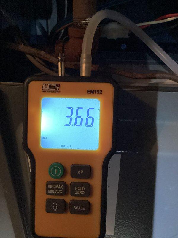 Performed routine heating tune-up service on the system. Conducted electrical diagnostics with multimeter showing 0.31A current draw and 0.065V, confirming proper electrical operation. Measured gas pressure with manometer reading at 3.66" WC, verifying correct gas supply to unit. Air conditioning system operational but not tested during this heating maintenance visit.