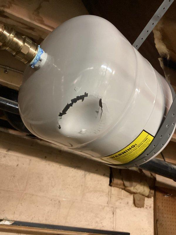 Responded to emergency service call for water leakage in basement. Diagnosed and replaced damaged expansion tank that had developed a significant crack, causing water spray. Unit was connected to Bradford White water heater system with proper fittings and tested to ensure proper operation and no further leakage.