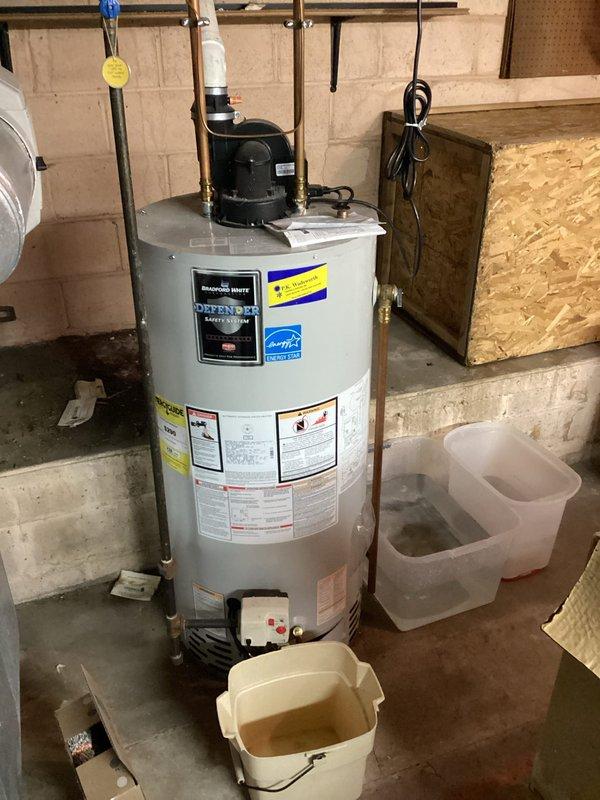 Responded to emergency service call for water leakage in basement. Diagnosed and replaced damaged expansion tank that had developed a significant crack, causing water spray. Unit was connected to Bradford White water heater system with proper fittings and tested to ensure proper operation and no further leakage.