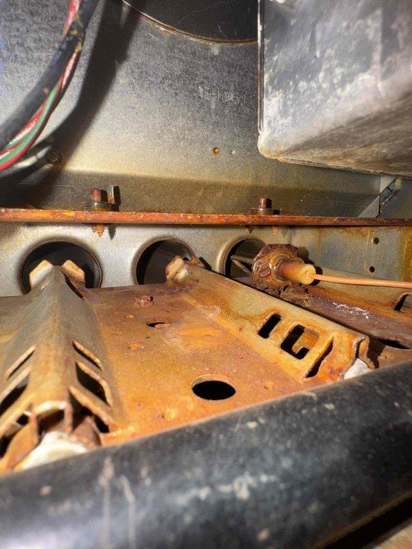 Performed scheduled maintenance on dual heating systems. Observed significant corrosion and rust on heat exchanger panel and blower housing. Noted motor and electrical connections remain functional despite age-related wear on equipment.