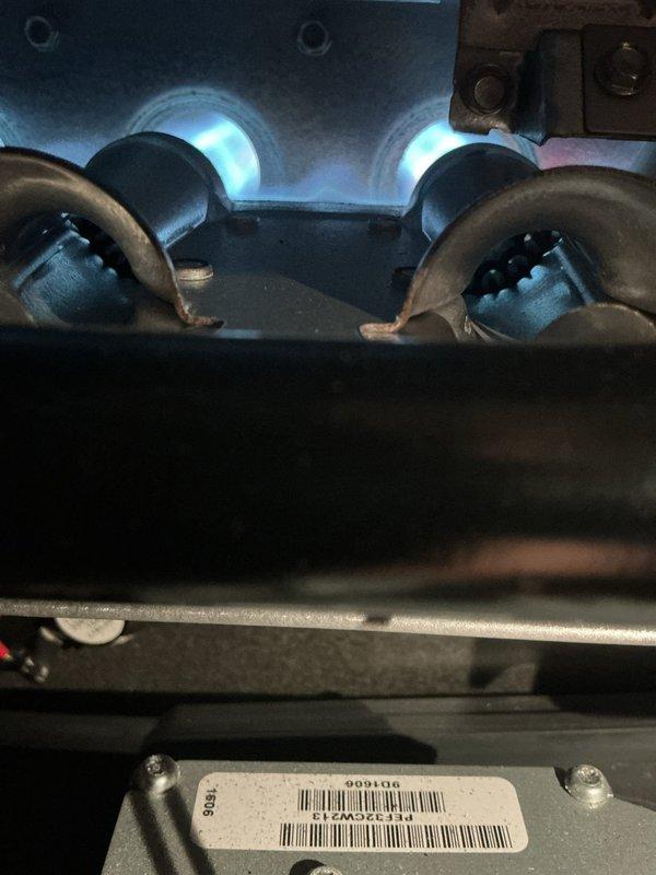 Performed monthly heating maintenance on a Carrier furnace. Inspected burner assembly and verified proper flame pattern with consistent blue flames. System is operating correctly with no issues observed.