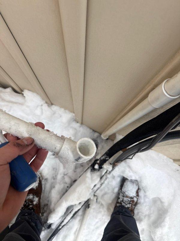 Responded to no hot water complaint for tankless water heater. Discovered frozen inlet water pipe due to extreme cold weather conditions. Thawed frozen pipe and restored water flow to unit, allowing system to resume normal operation. Advised customer on preventative measures to protect exterior plumbing components during freezing temperatures.