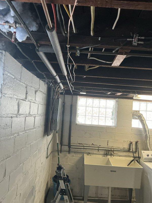 Completed grounding system upgrade in unfinished basement area. Installed new main grounding electrode conductor and bonding connections to meet current electrical code requirements. Verified proper continuity and resistance values for all ground connections at electrical panel.