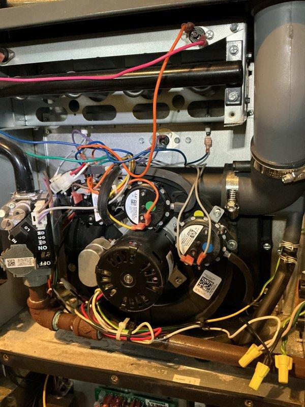 Completed scheduled heating maintenance on Amana furnace system. Inspected internal components including blower assembly, electrical connections, and ventilation pipes, confirming all components are properly secured and functioning. System appears to be in good working condition with no visible damage or deterioration.