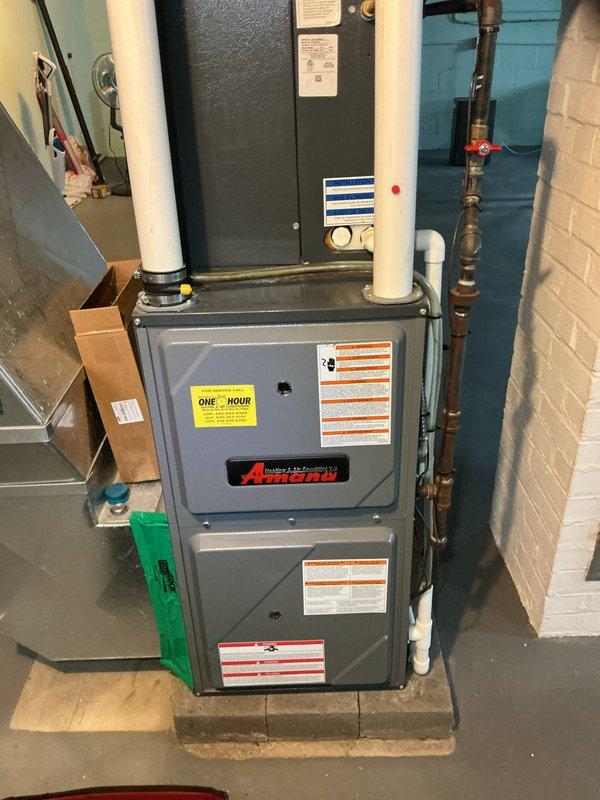 Completed scheduled heating maintenance on Amana furnace system. Inspected internal components including blower assembly, electrical connections, and ventilation pipes, confirming all components are properly secured and functioning. System appears to be in good working condition with no visible damage or deterioration.