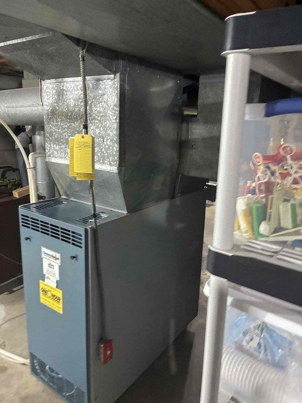 Conducted a quote assessment for whole house humidifier installation. Inspected the existing furnace system with attached ductwork in the utility room, noting available connection points and installation requirements. Evaluated water supply access near the A.O. Smith water heater to determine optimal humidifier placement and connection options.