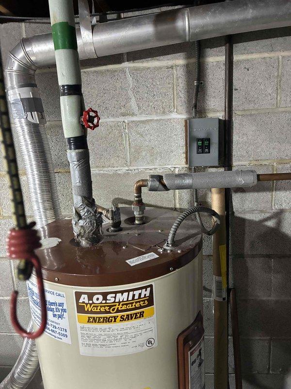 Conducted a quote assessment for whole house humidifier installation. Inspected the existing furnace system with attached ductwork in the utility room, noting available connection points and installation requirements. Evaluated water supply access near the A.O. Smith water heater to determine optimal humidifier placement and connection options.
