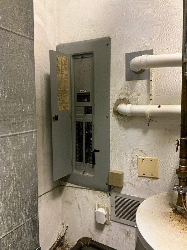 Conducted estimate for installation of Unico HVAC system in the older section of residence currently lacking air conditioning. Inspection revealed electrical panel with adequate service capacity, though significant water damage was observed on adjacent walls near PVC piping. Ceiling assessment identified compromised acoustic tiles with visible ductwork access, which will require repair during system installation.