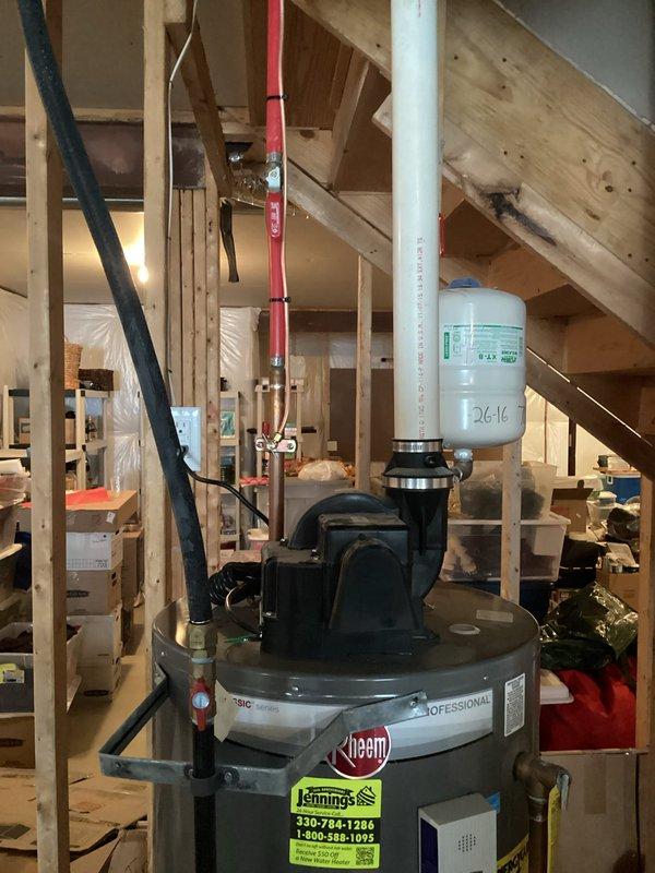 Conducted a complimentary assessment of existing Rheem water heater installation for replacement quote. Current unit is a 40-gallon vented model with expansion tank and standard plumbing connections. Observed installation area in partially finished basement with adequate clearance for replacement. Customer seeking competitive pricing options after receiving multiple estimates from other providers.