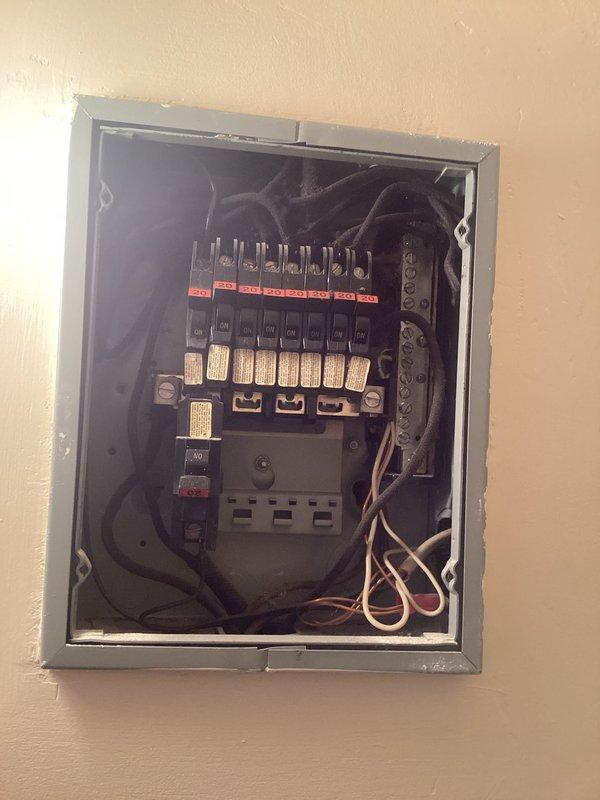 Performed comprehensive evaluation of customer's electrical panel for quote request. Panel inspection revealed aging circuit breakers with visible red trip indicators, disorganized internal wiring, and potential moisture damage to surrounding wall structure. Documented existing conditions with photos for accurate estimation of panel replacement or upgrade requirements.