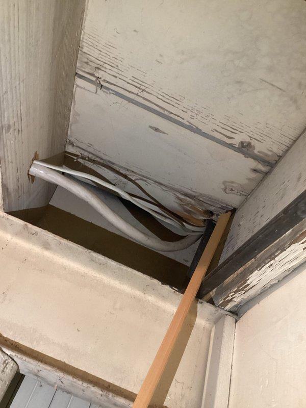 Performed comprehensive evaluation of customer's electrical panel for quote request. Panel inspection revealed aging circuit breakers with visible red trip indicators, disorganized internal wiring, and potential moisture damage to surrounding wall structure. Documented existing conditions with photos for accurate estimation of panel replacement or upgrade requirements.