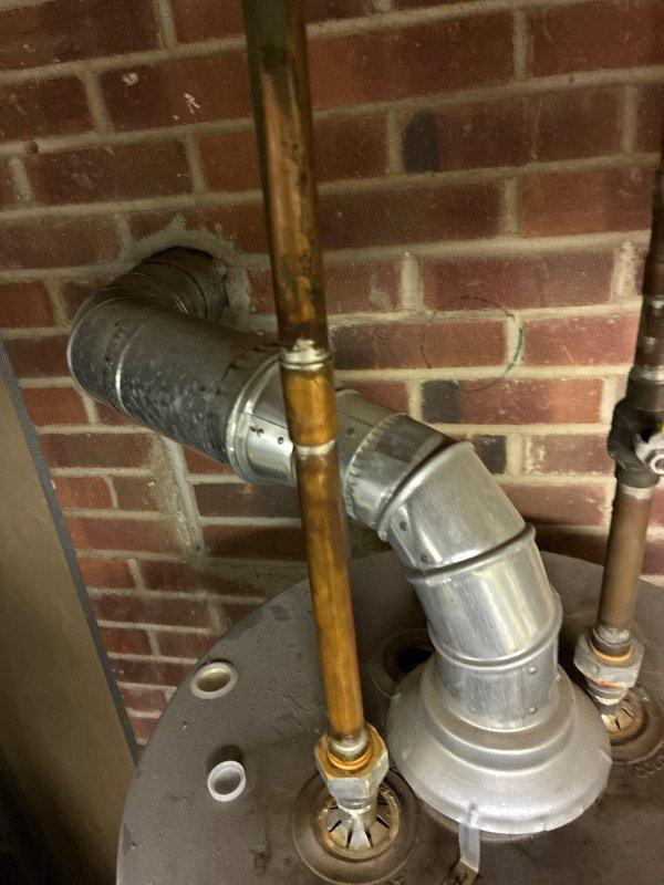 Responded to no-heat service call. Inspected electrical panels and connections in utility area. Examined ventilation ductwork and copper piping showing oxidation near furnace unit. Recommended complete system replacement due to age and condition of components.