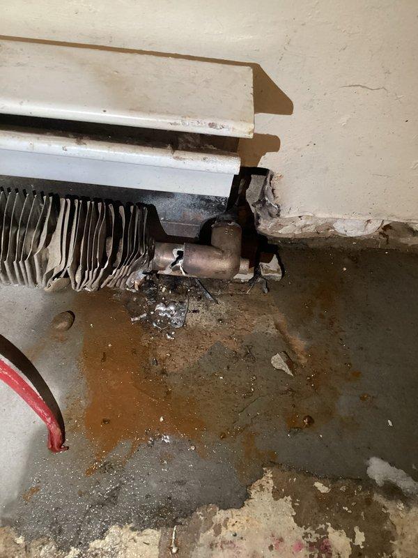 Completed repair of leaking elbow on fin tube heating element adjacent to garage door. Isolated boiler from system, capped piping and pressurized to 30 psi for leak test. Addressed significant water damage at baseboard connection point where deterioration had occurred to surrounding wall material and floor surface.